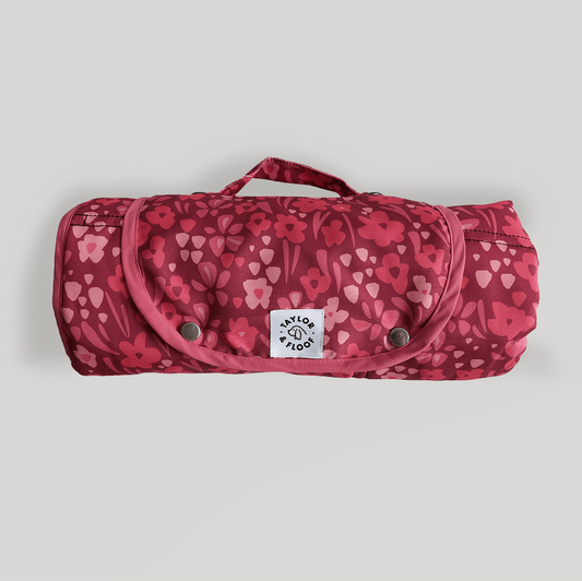 Blush Blossom settle mat rolled up with popper closure, featuring a pink floral design and non-slip base for dogs.