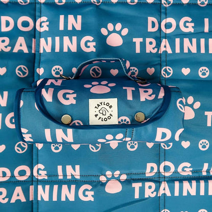 Non-slip Dog in Training settle mat with a stylish dark blue and pink design for puppies.