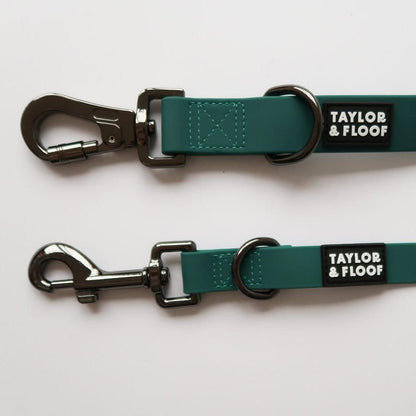 Close-up of a hands free dog lead with adjustable strap and buckle. Small and large size in the dark teal colour. 